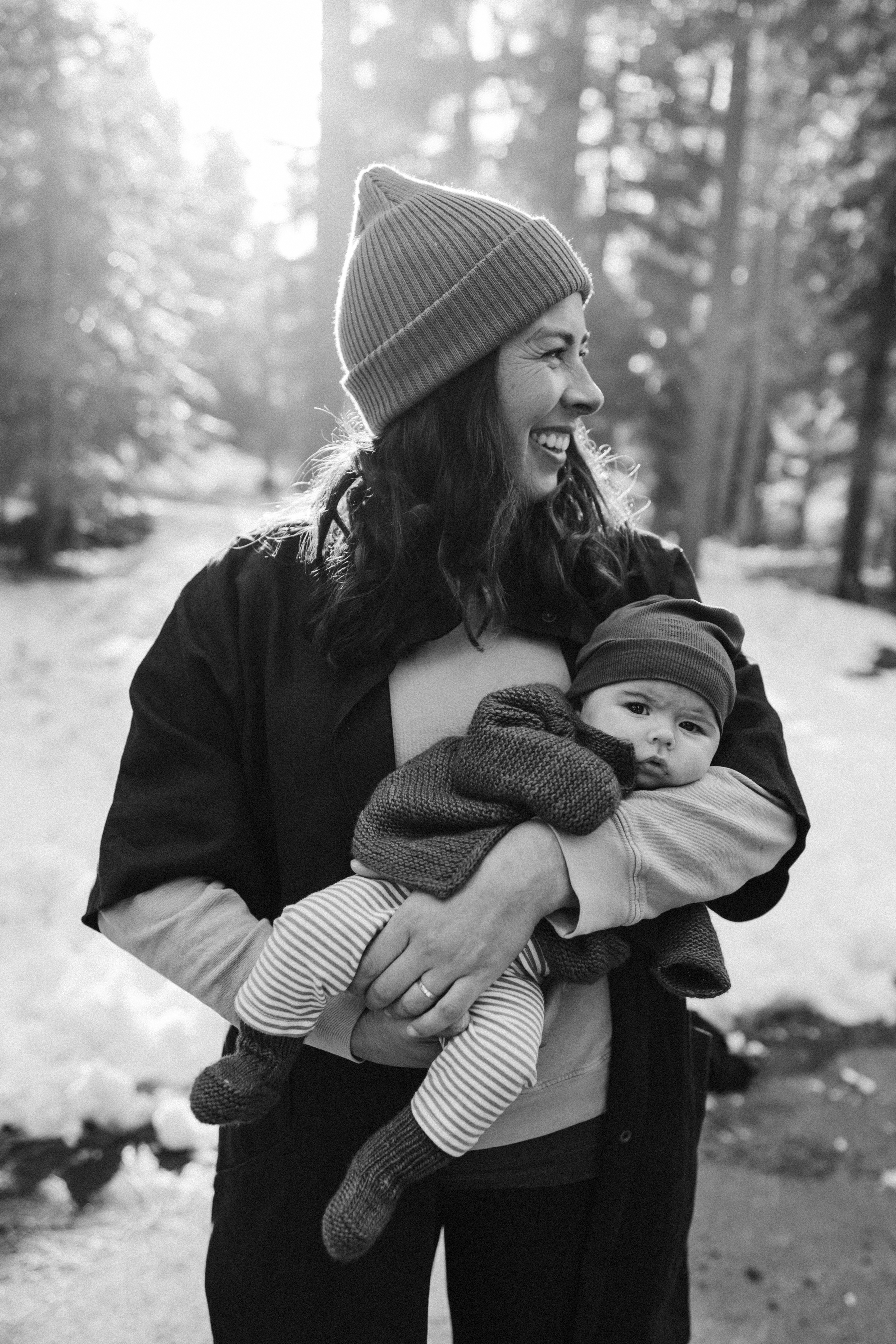 Happy mother holding her baby outdoors
